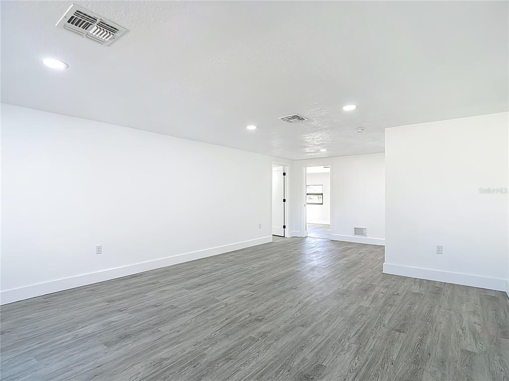 8130 San Felipe Court Port Richey, FL 34668 - Photo 2 of 54 a view of empty room with wooden floor