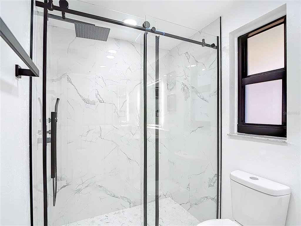 8130 San Felipe Court Port Richey, FL 34668 - Photo 28 of 54 a bathroom with a shower and a toilet