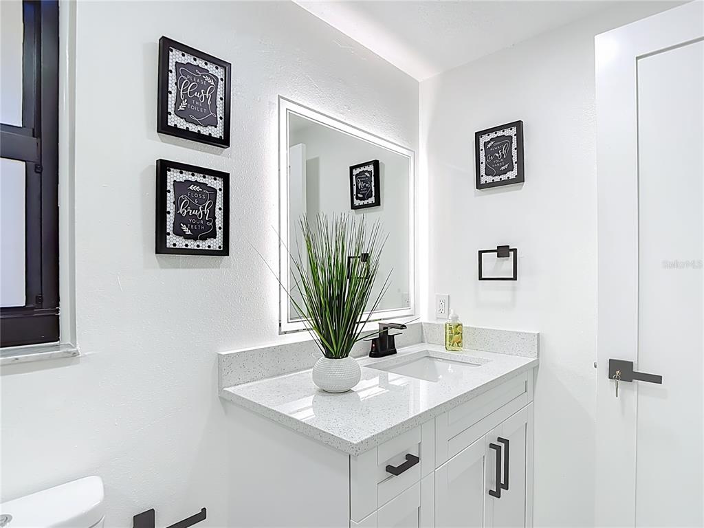 8130 San Felipe Court Port Richey, FL 34668 - Photo 29 of 54 a view of bathroom sink and a mirror