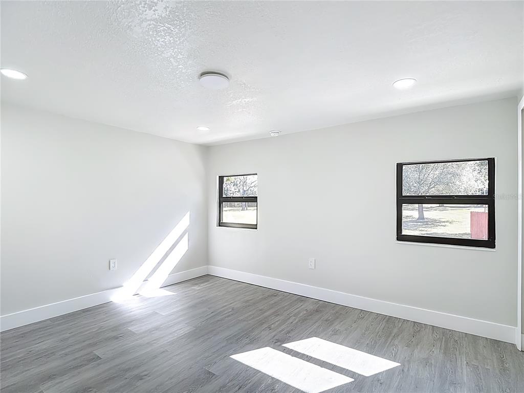 8130 San Felipe Court Port Richey, FL 34668 - Photo 30 of 54 wooden floor in an empty room with a window