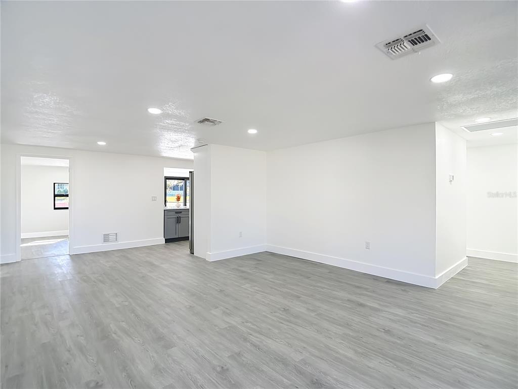 8130 San Felipe Court Port Richey, FL 34668 - Photo 3 of 54 an empty room with wooden floor and windows