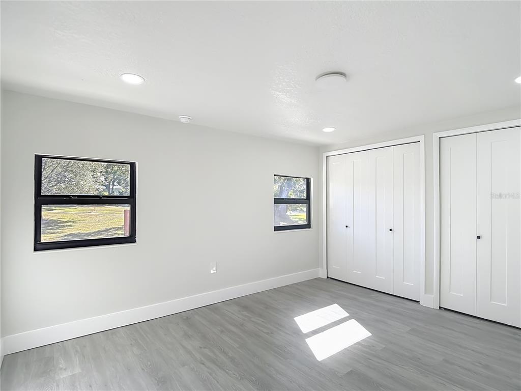 8130 San Felipe Court Port Richey, FL 34668 - Photo 33 of 54 a view of a big room with wooden floor and windows