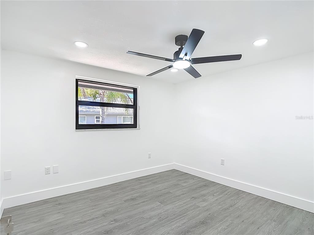 8130 San Felipe Court Port Richey, FL 34668 - Photo 34 of 54 a view of a big room with wooden floor and windows