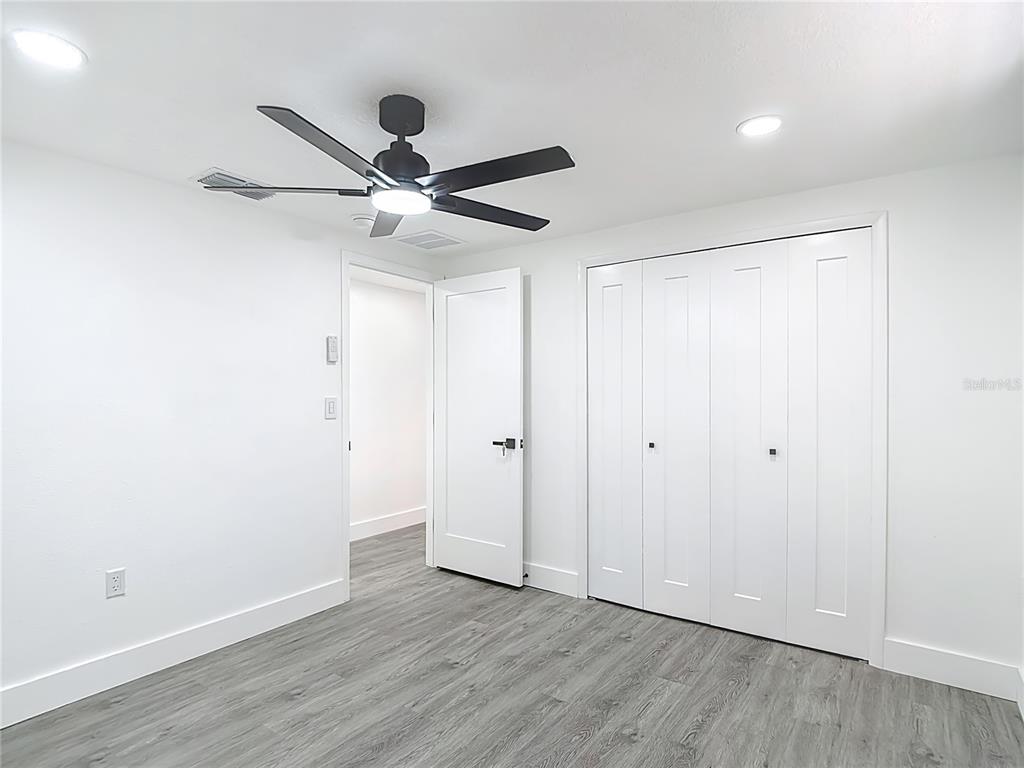 8130 San Felipe Court Port Richey, FL 34668 - Photo 36 of 54 a view of an empty room with wooden floor