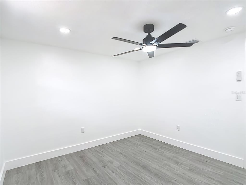 8130 San Felipe Court Port Richey, FL 34668 - Photo 37 of 54 wooden floor in an empty room