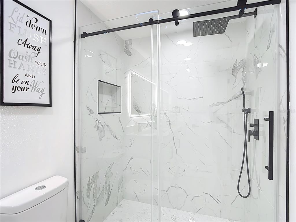 8130 San Felipe Court Port Richey, FL 34668 - Photo 39 of 54 a bathroom with a shower and a toilet