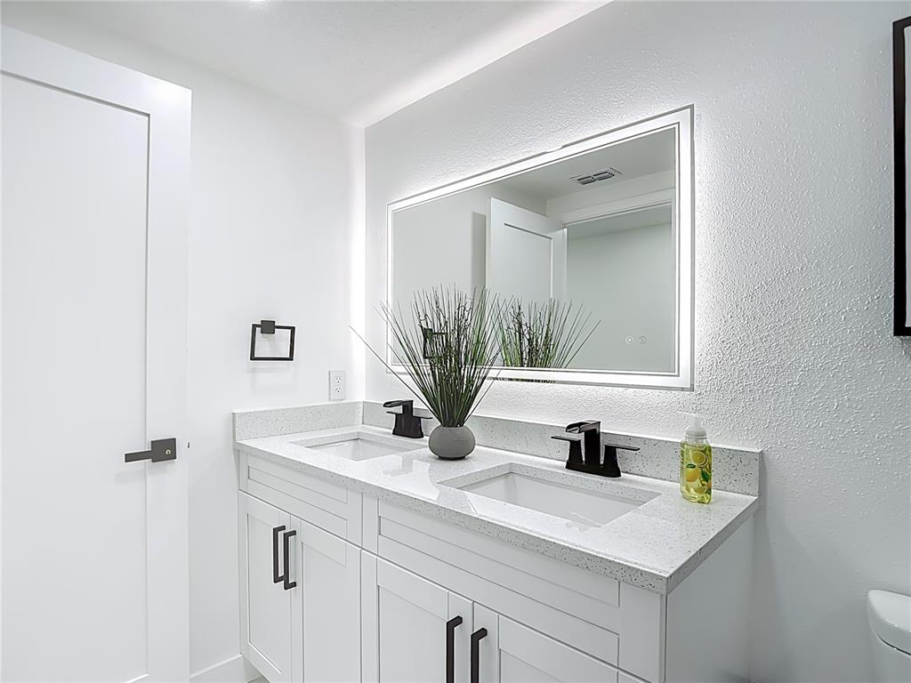 8130 San Felipe Court Port Richey, FL 34668 - Photo 40 of 54 a bathroom with a sink a vanity and a mirror