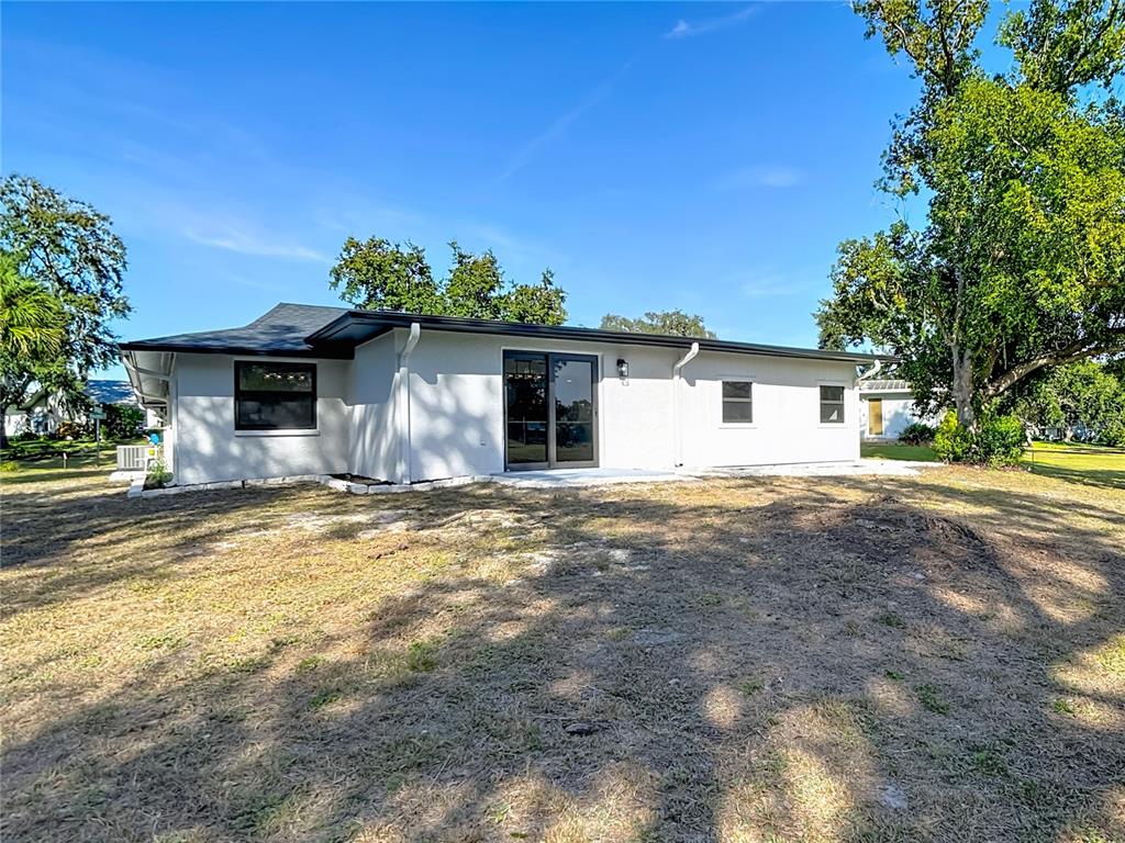 8130 San Felipe Court Port Richey, FL 34668 - Photo 47 of 54 a view of a house with backyard and garden