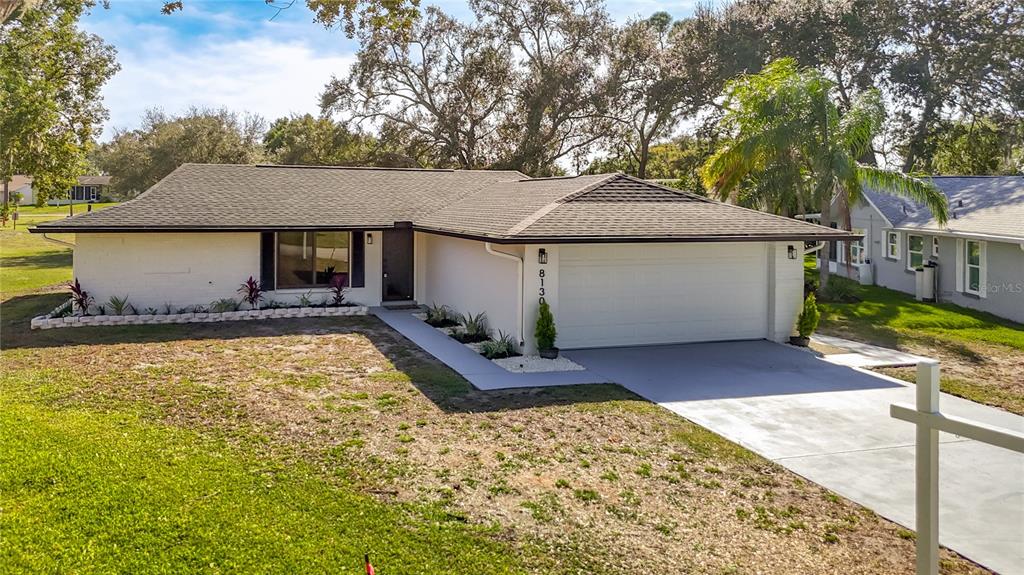 8130 San Felipe Court Port Richey, FL 34668 - Photo 54 of 54 a front view of a house with a yard