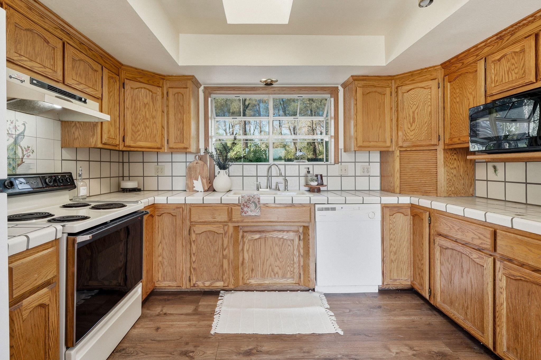5941 Oak Street Anderson, CA 96007 - Photo 7 of 14 a kitchen with stainless steel appliances granite countertop a stove a sink and a microwave
