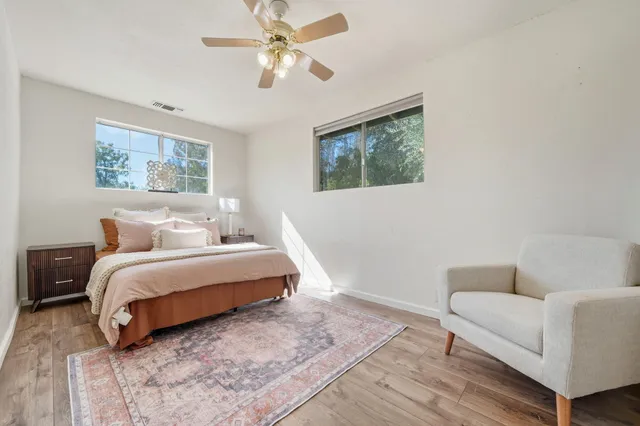 a spacious bedroom with a bed couch and a window