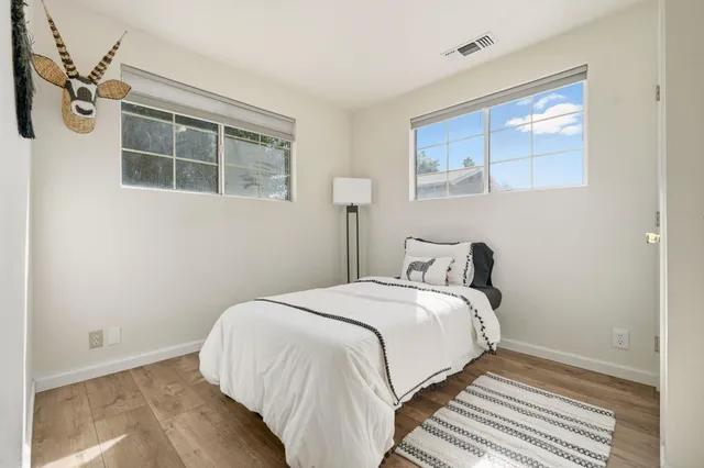 a bedroom with a bed and a window