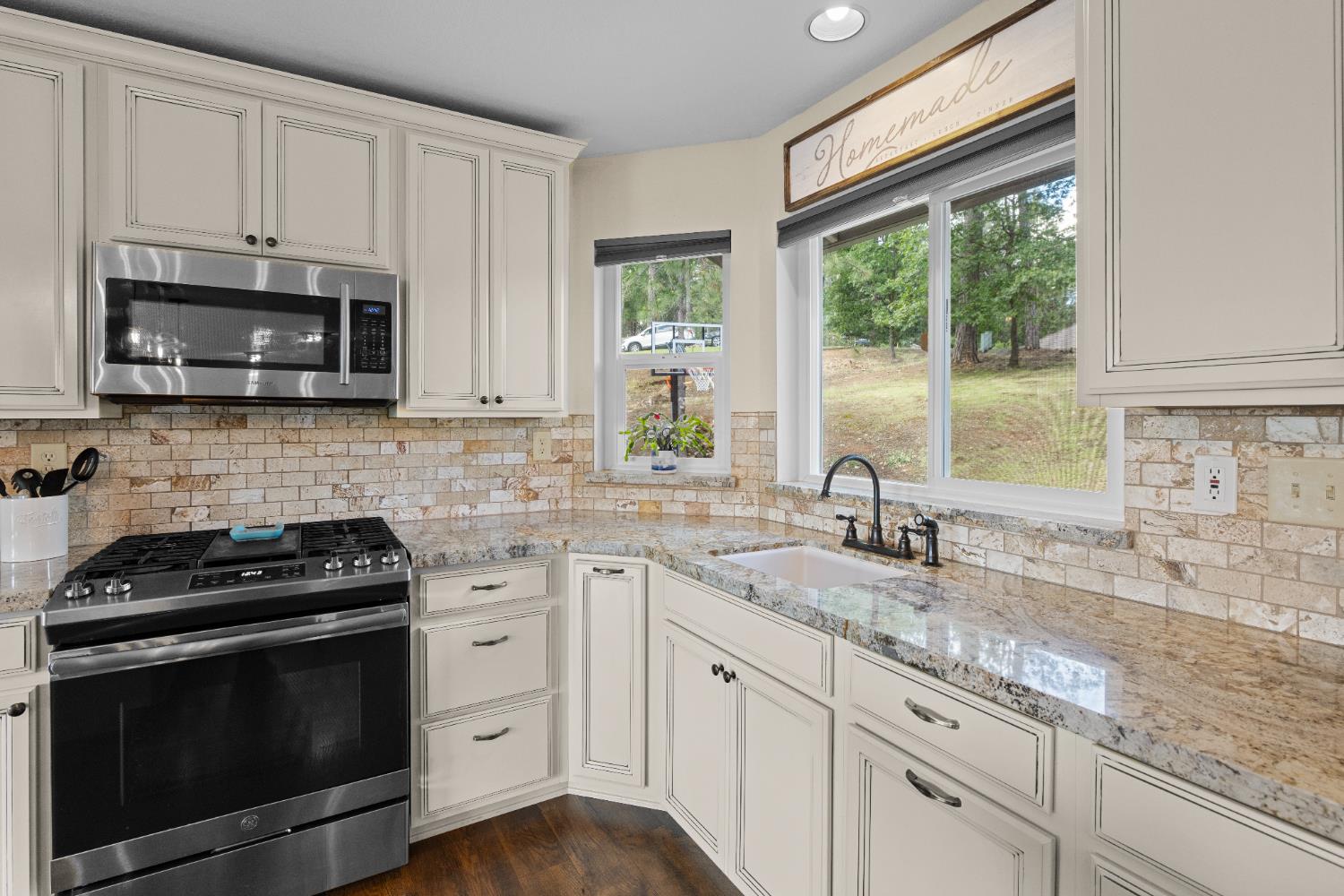 6139 Green Ridge Drive Foresthill, CA 95631 - Photo 8 of 30 a kitchen with stainless steel appliances granite countertop white cabinets granite counter tops and a window