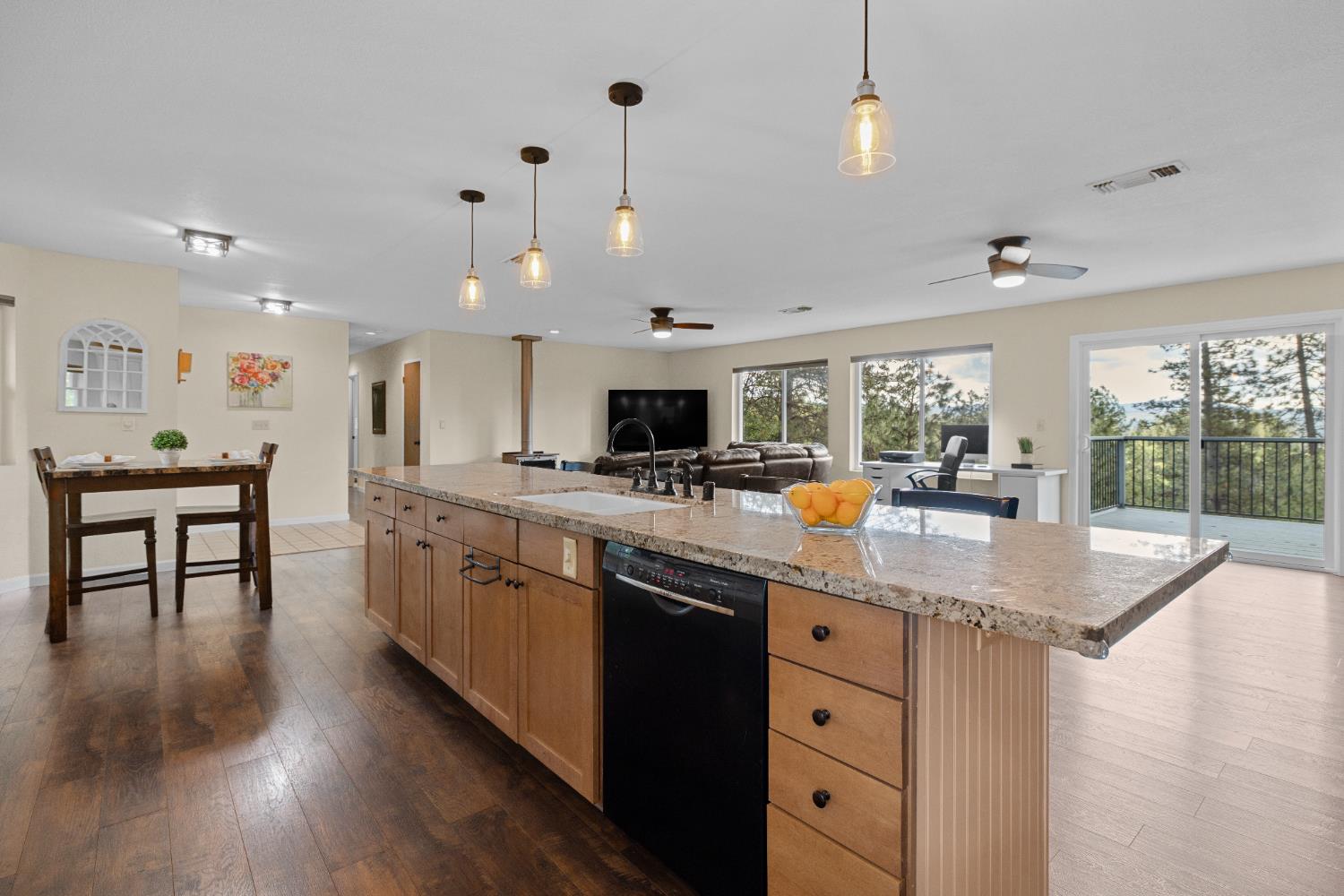6139 Green Ridge Drive Foresthill, CA 95631 - Photo 10 of 30 a kitchen with stainless steel appliances granite countertop a sink stove and wooden floor