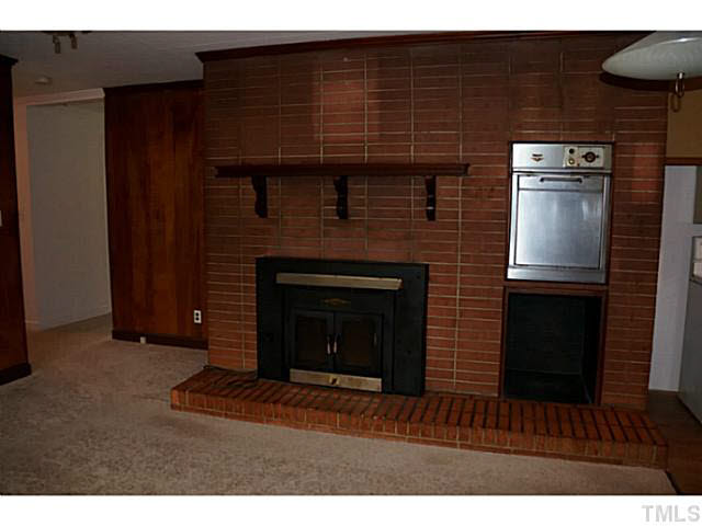 134 Log Barn Road Pittsboro, NC 27312 - Photo 9 of 25 Wood stone masonry fireplace.