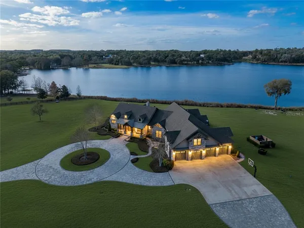 an aerial view of a house with outdoor space lake view and boat