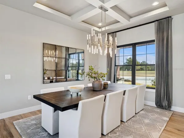 a kitchen with kitchen island granite countertop a table chairs sink and cabinets