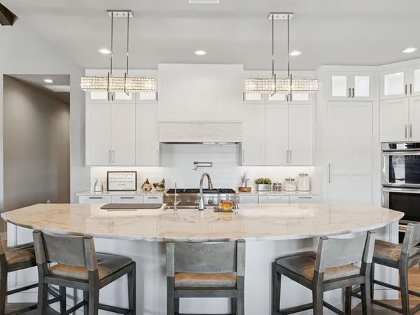 a living room with furniture and floor to ceiling windows