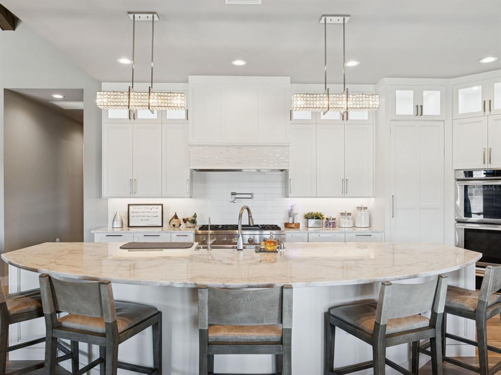 22151 Lake Seneca Road Eustis, FL 32736 - Photo 17 of 77 a kitchen with kitchen island granite countertop a table and chairs in it