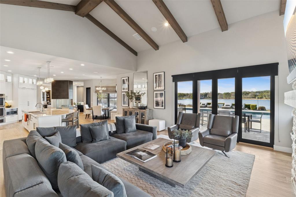 22151 Lake Seneca Road Eustis, FL 32736 - Photo 24 of 77 a living room with furniture and floor to ceiling windows