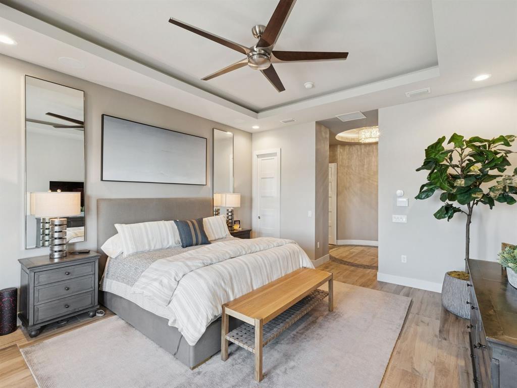 22151 Lake Seneca Road Eustis, FL 32736 - Photo 29 of 77 a bedroom with a bed and a potted plant