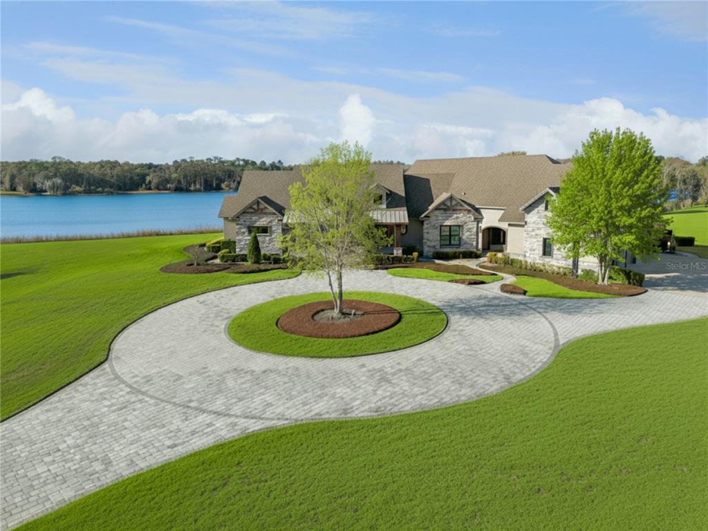 22151 Lake Seneca Road Eustis, FL 32736 - Photo 3 of 77 a view of a garden with lawn chairs