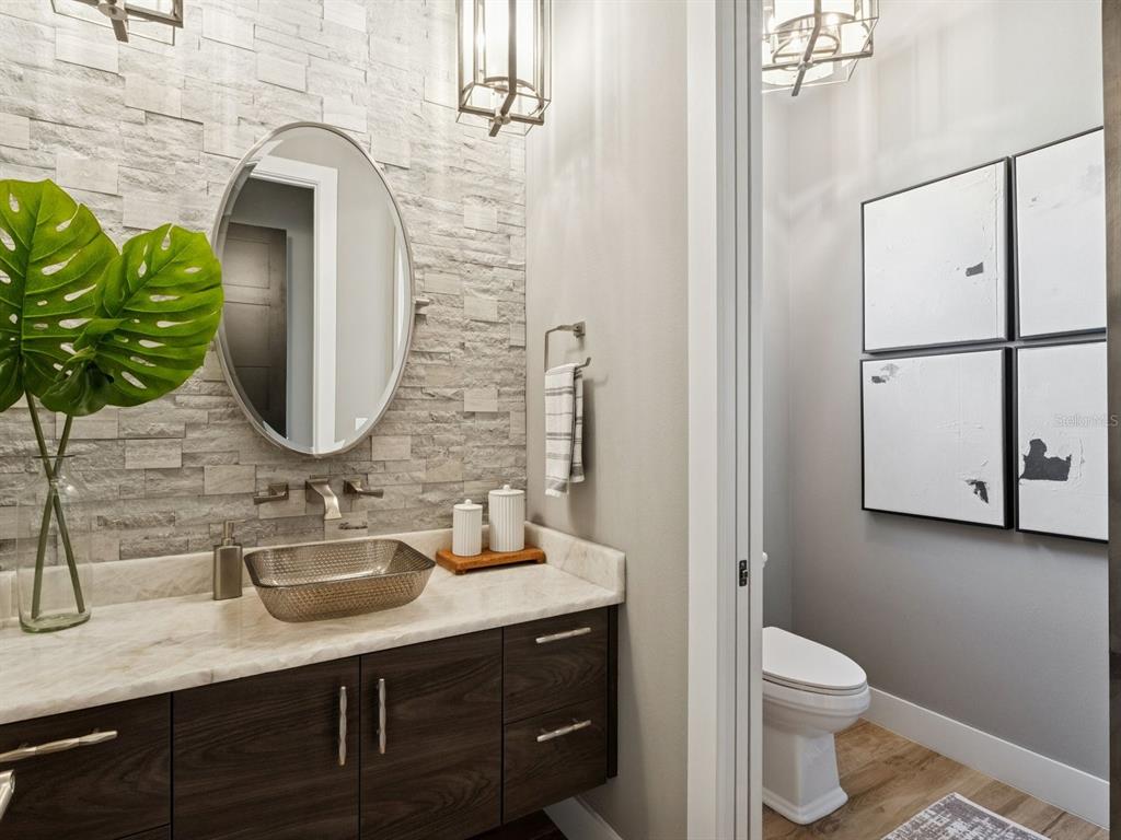 22151 Lake Seneca Road Eustis, FL 32736 - Photo 39 of 77 a bathroom with a toilet sink and mirror