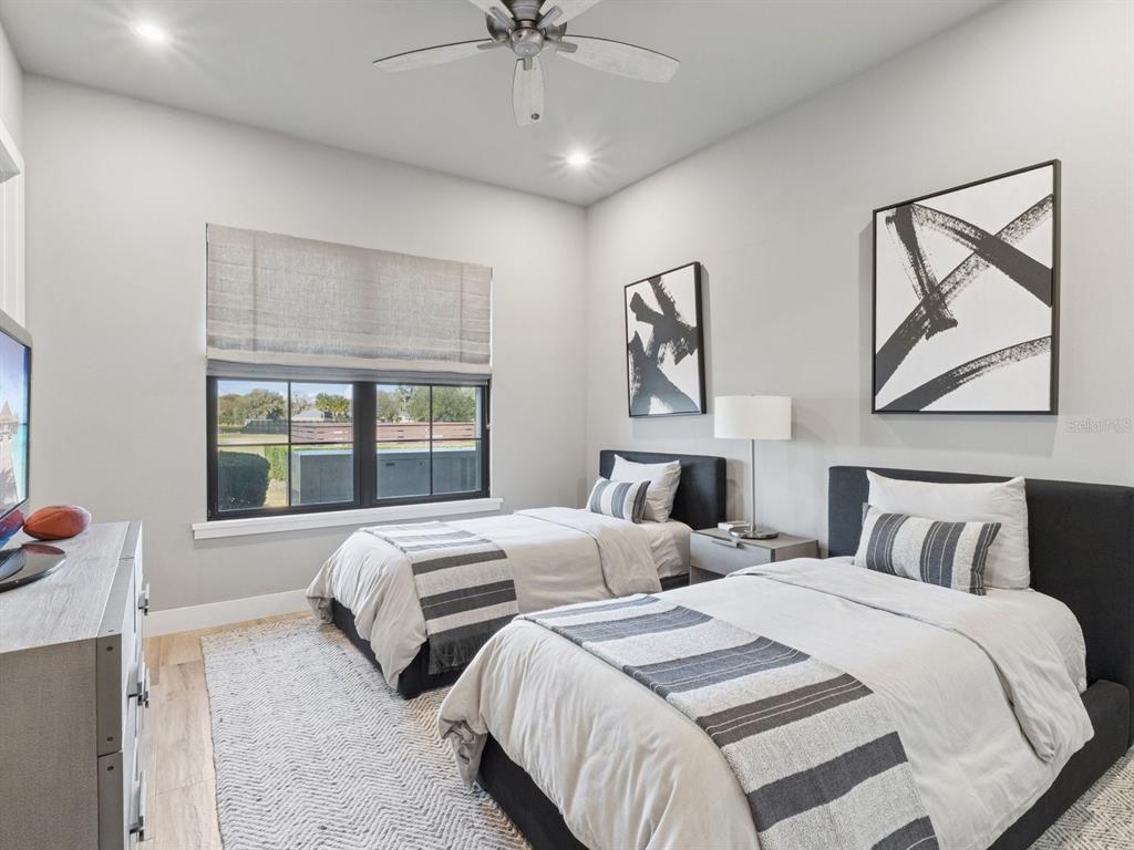 22151 Lake Seneca Road Eustis, FL 32736 - Photo 40 of 77 a bedroom with two beds and a large window