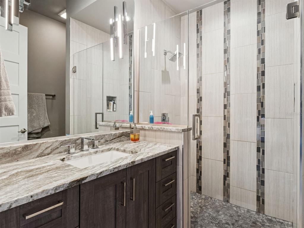 22151 Lake Seneca Road Eustis, FL 32736 - Photo 43 of 77 a bathroom with a granite countertop sink and a mirror