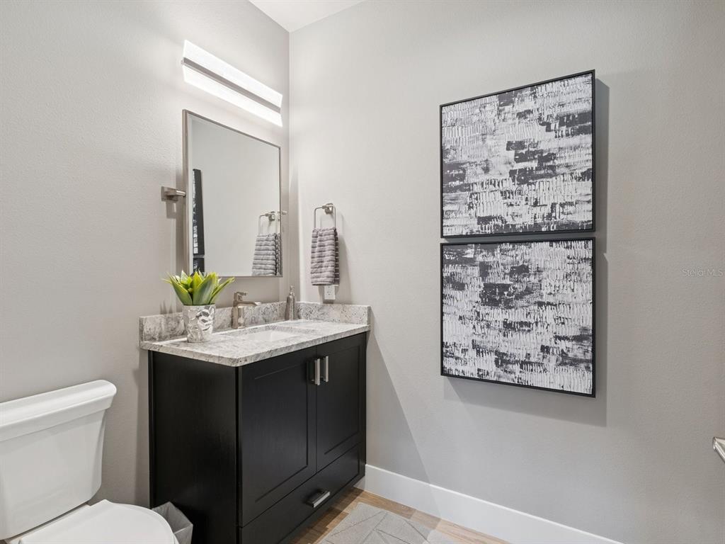 22151 Lake Seneca Road Eustis, FL 32736 - Photo 51 of 77 a bathroom with a toilet sink and mirror
