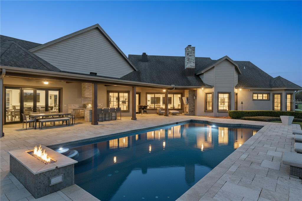 22151 Lake Seneca Road Eustis, FL 32736 - Photo 54 of 77 a view of a house with swimming pool and sitting area