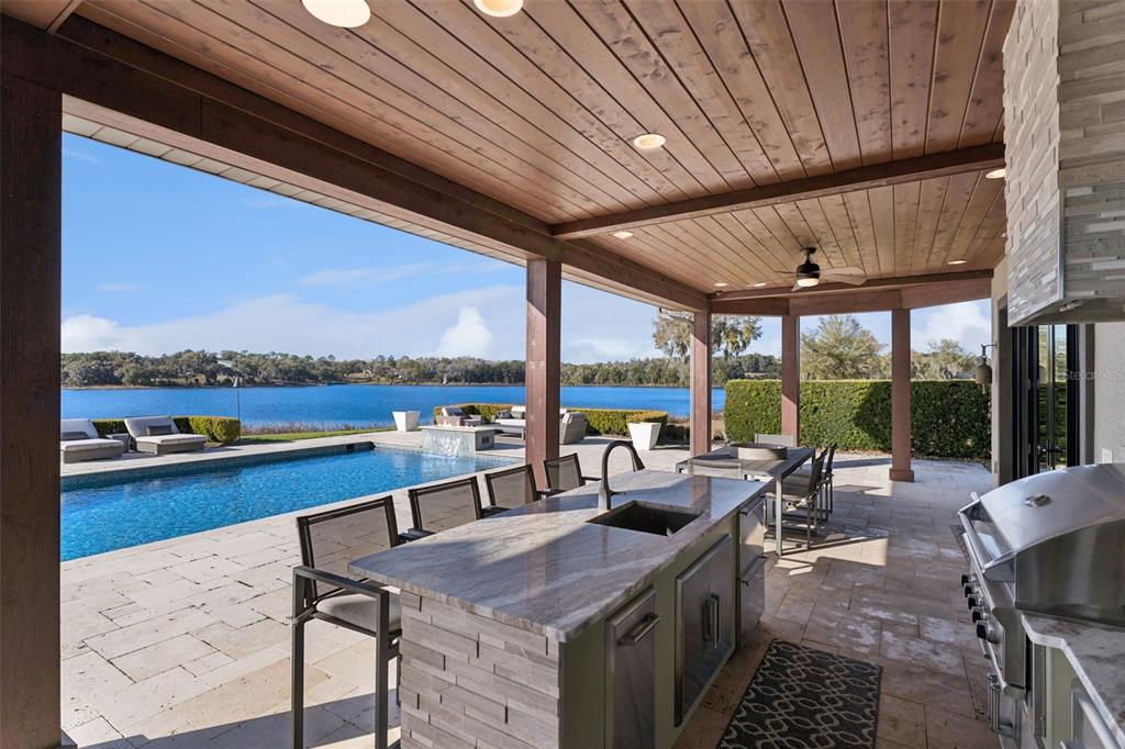 22151 Lake Seneca Road Eustis, FL 32736 - Photo 57 of 77 a view of a patio with lawn chairs floor to ceiling window and an outdoor space