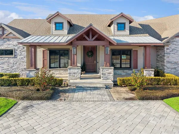 a front view of a house with garden