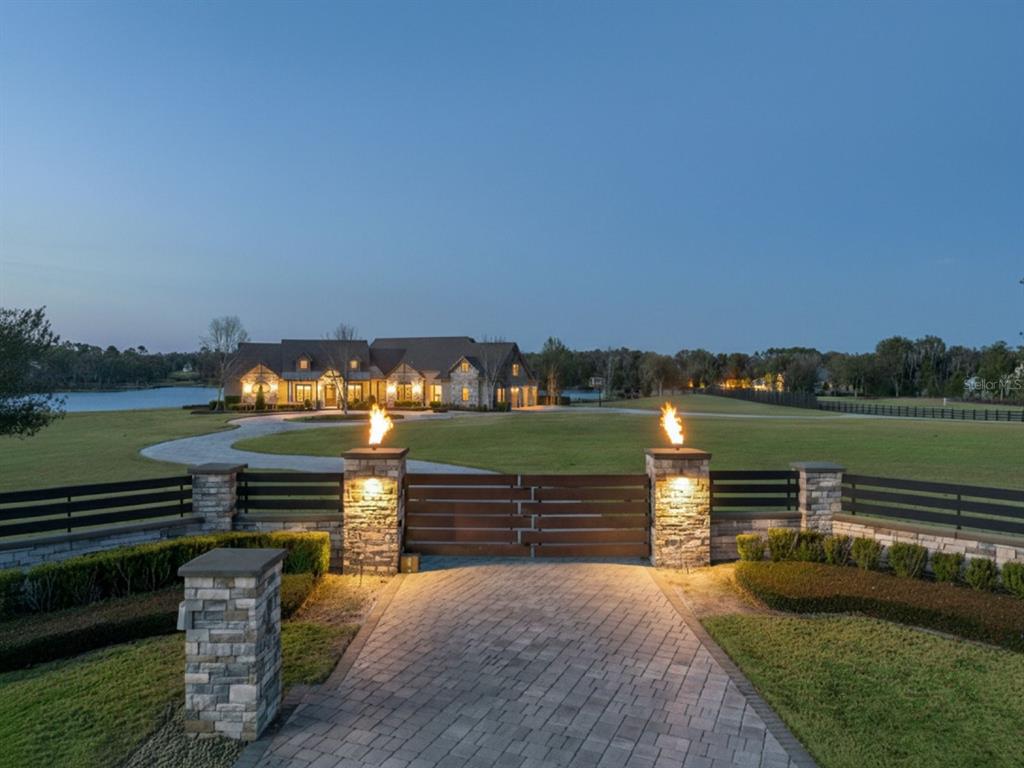 22151 Lake Seneca Road Eustis, FL 32736 - Photo 62 of 77 a view of a lake with a bench in front of house