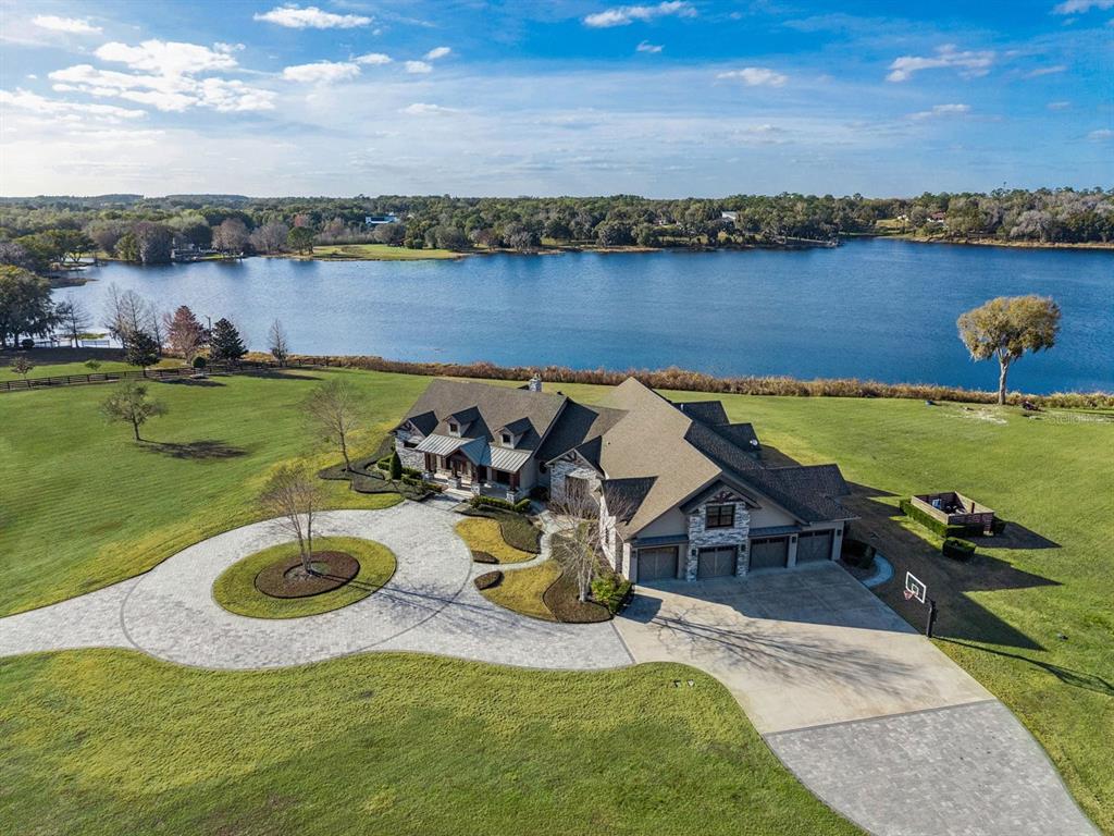 22151 Lake Seneca Road Eustis, FL 32736 - Photo 63 of 77 an aerial view of a house with swimming pool and lake view