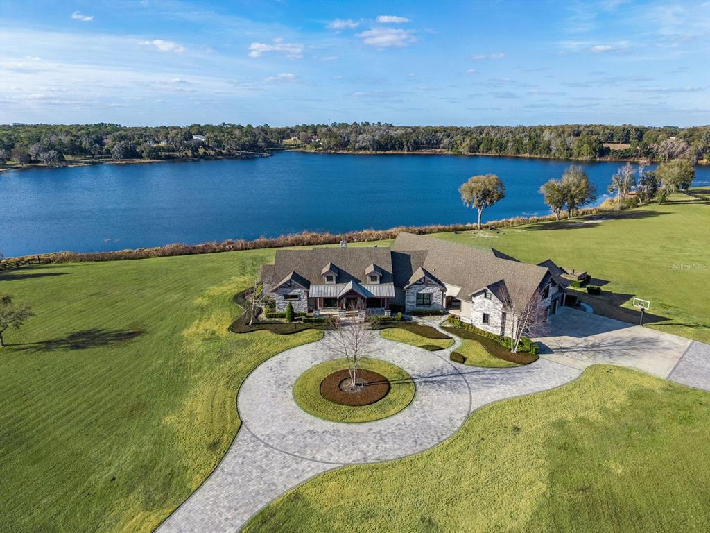 22151 Lake Seneca Road Eustis, FL 32736 - Photo 64 of 77 an aerial view of a house with swimming pool and lake view