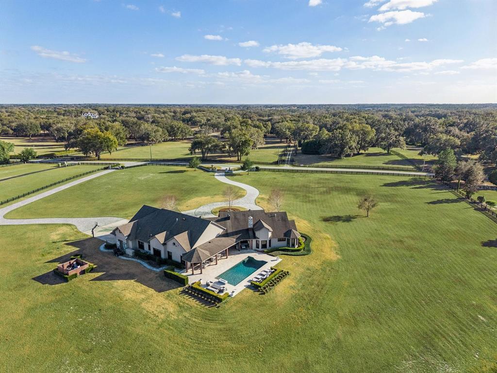 22151 Lake Seneca Road Eustis, FL 32736 - Photo 69 of 77 an aerial view of a house with a swimming pool yard and outdoor seating