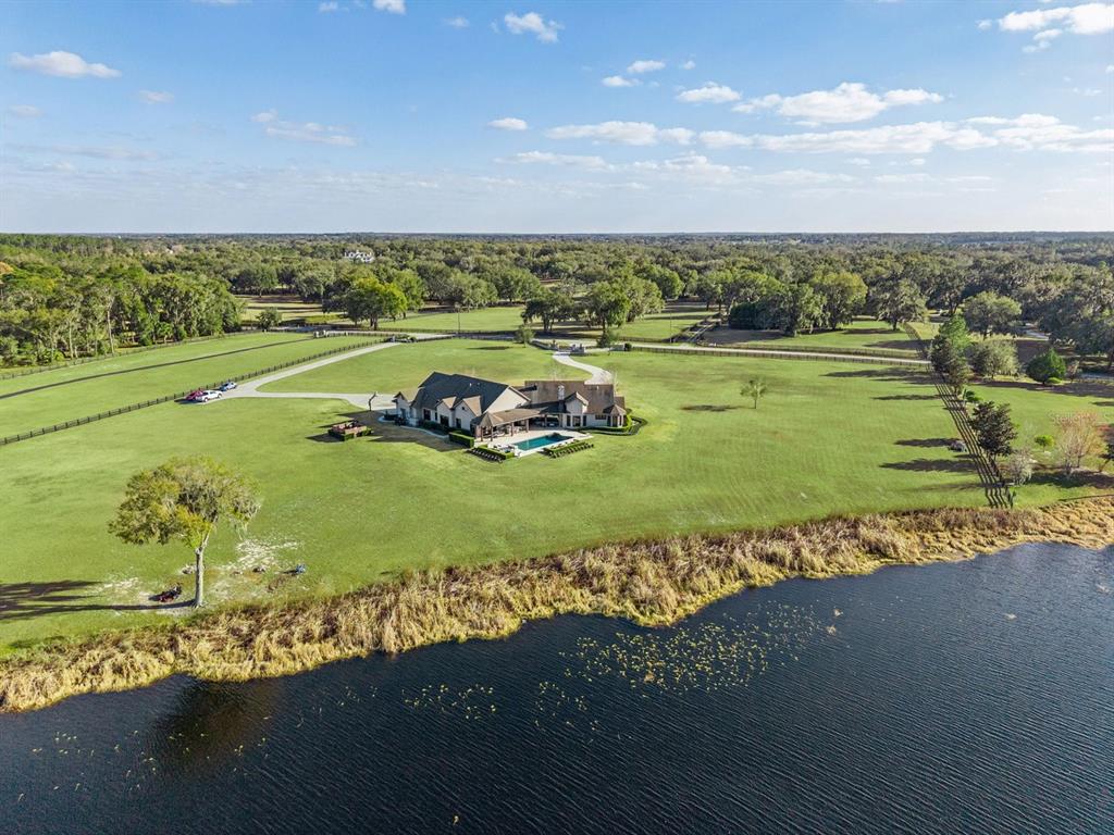 22151 Lake Seneca Road Eustis, FL 32736 - Photo 70 of 77 an aerial view of a golf course with a ocean view
