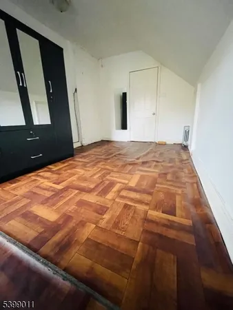 a bedroom with a bed and a mirror