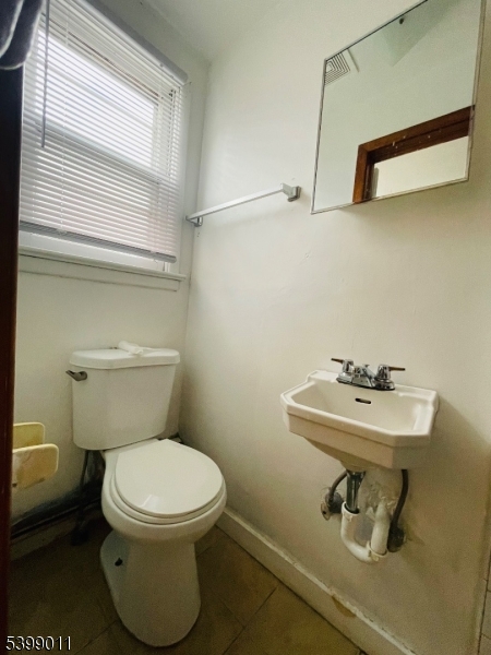 123 Cherry Street, Unit 3 Elizabeth, NJ 07202 - Photo 6 of 11 a bathroom with a sink a toilet and mirror