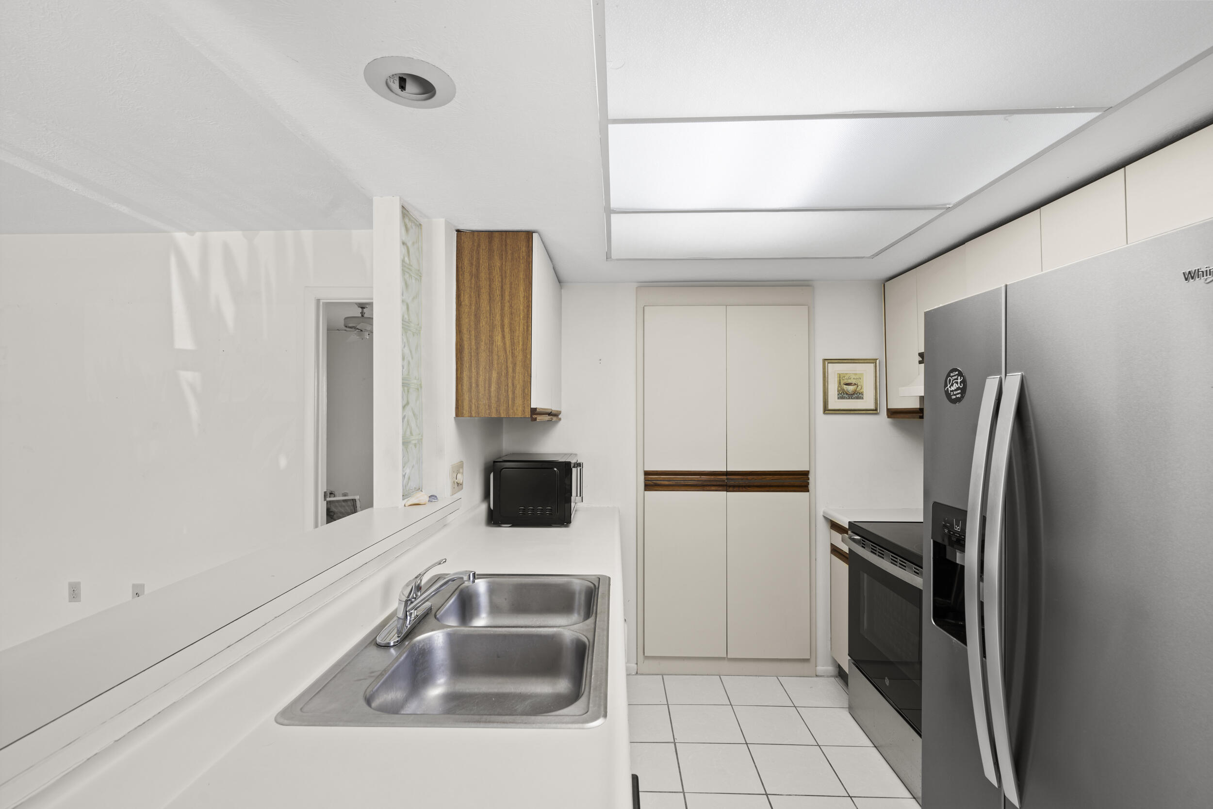 3278 Southeast Aster Lane, Unit F155 Stuart, FL 34994 - Photo 12 of 41 a kitchen with a sink appliances and cabinets