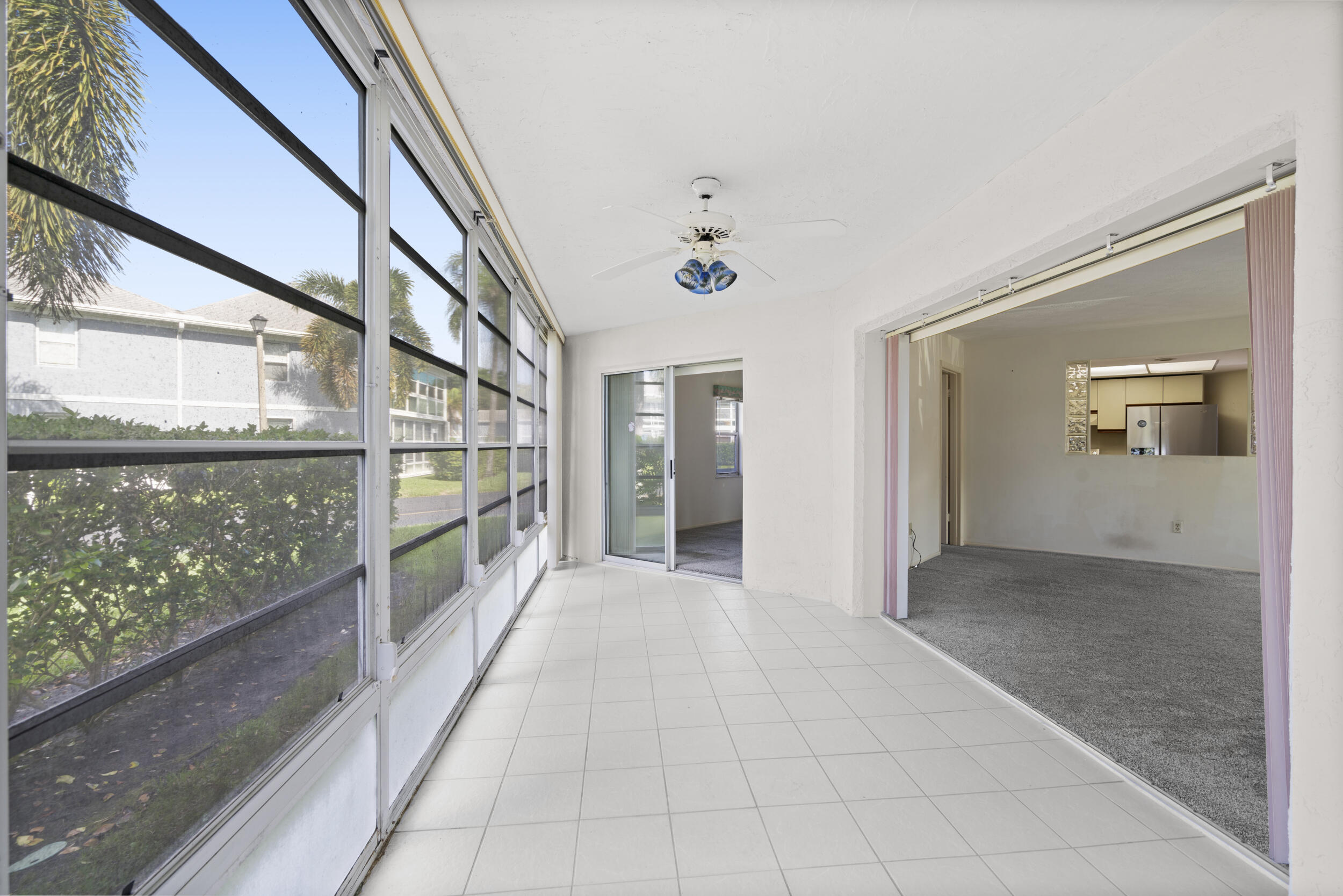 3278 Southeast Aster Lane, Unit F155 Stuart, FL 34994 - Photo 14 of 41 a view of a big room with a floor to ceiling window