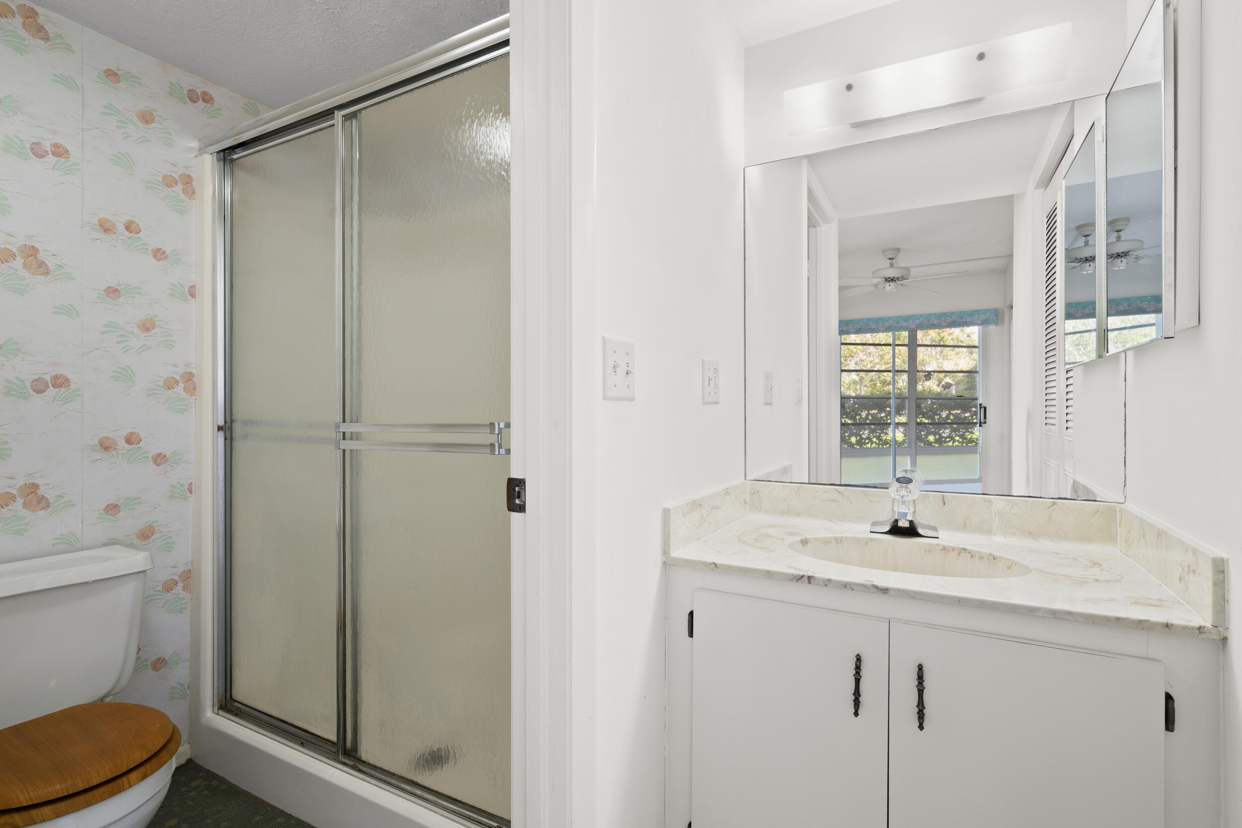 3278 Southeast Aster Lane, Unit F155 Stuart, FL 34994 - Photo 20 of 41 a bathroom with a sink a toilet and shower