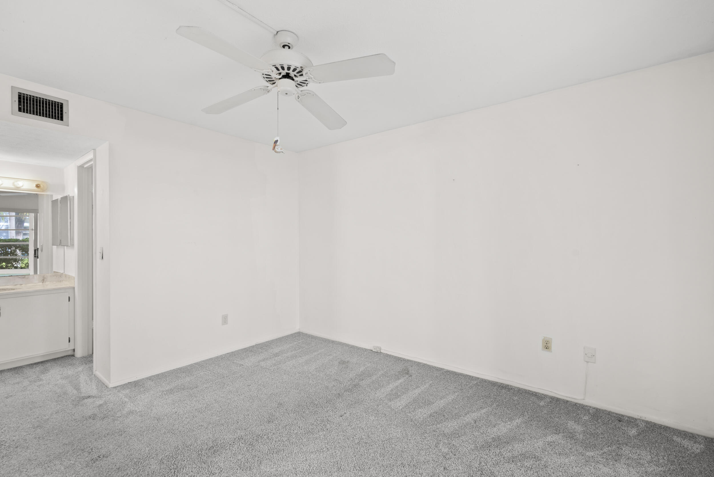 3278 Southeast Aster Lane, Unit F155 Stuart, FL 34994 - Photo 21 of 41 an empty room with a ceiling fan and a window