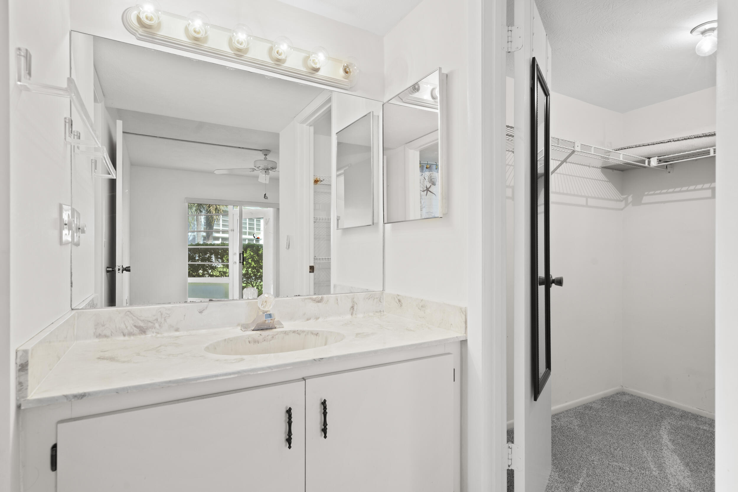 3278 Southeast Aster Lane, Unit F155 Stuart, FL 34994 - Photo 23 of 41 a bathroom with a sink and a mirror