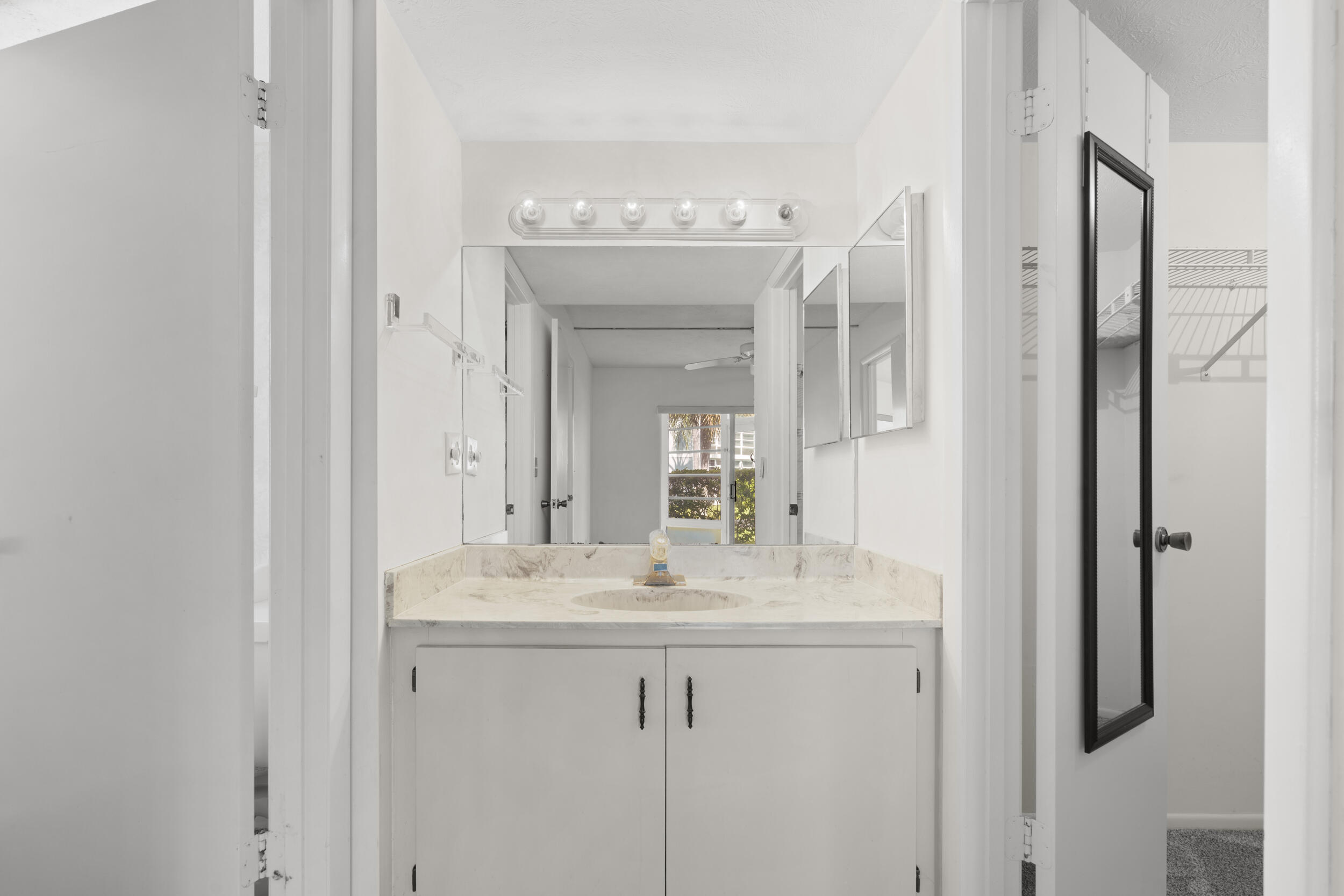 3278 Southeast Aster Lane, Unit F155 Stuart, FL 34994 - Photo 25 of 41 a bathroom with a sink and a mirror