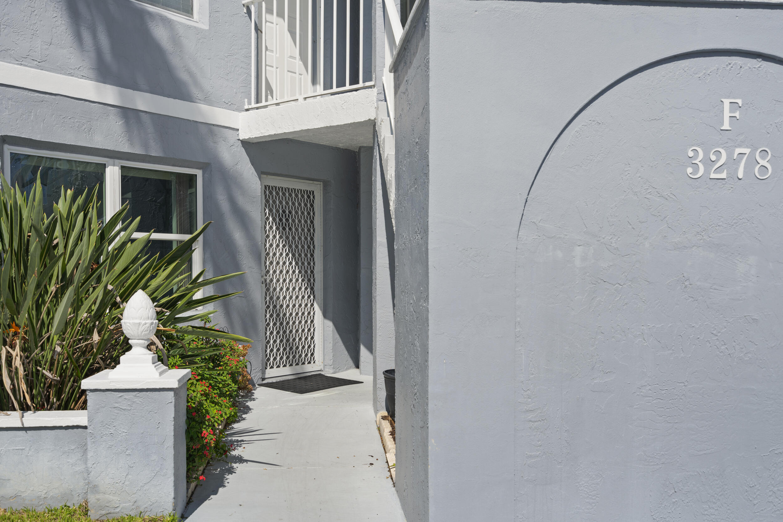 3278 Southeast Aster Lane, Unit F155 Stuart, FL 34994 - Photo 3 of 41 a view of a potted plants next to a wall