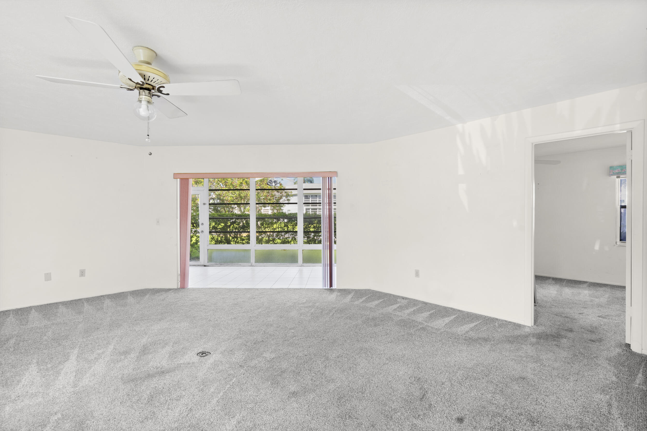 3278 Southeast Aster Lane, Unit F155 Stuart, FL 34994 - Photo 4 of 41 an empty room with a ceiling fan and a window