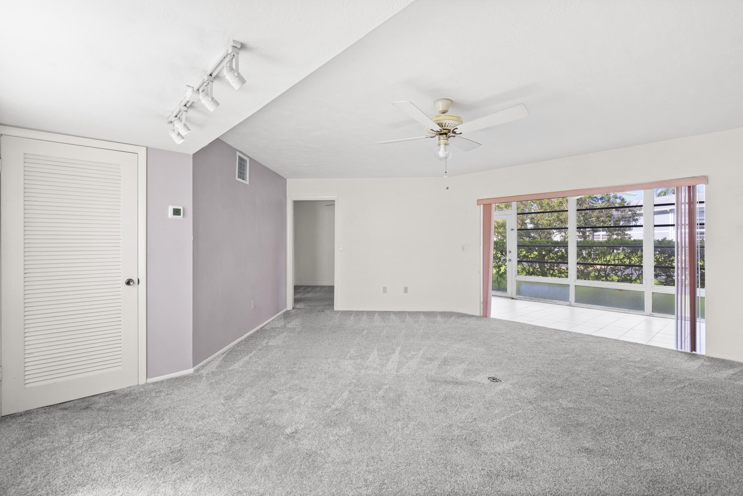 3278 Southeast Aster Lane, Unit F155 Stuart, FL 34994 - Photo 5 of 41 a view of a room with a ceiling fan and window