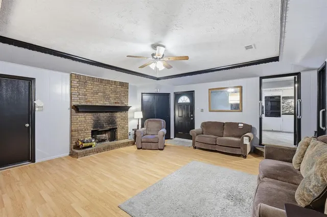 a living room with furniture flat screen tv and a fireplace